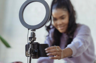 Woman adjusting a camera and light